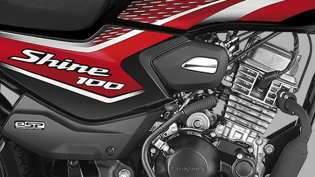 Close-up of Honda Shine 100 DX motorcycle parked on a roadside with shiny body and alloy wheels